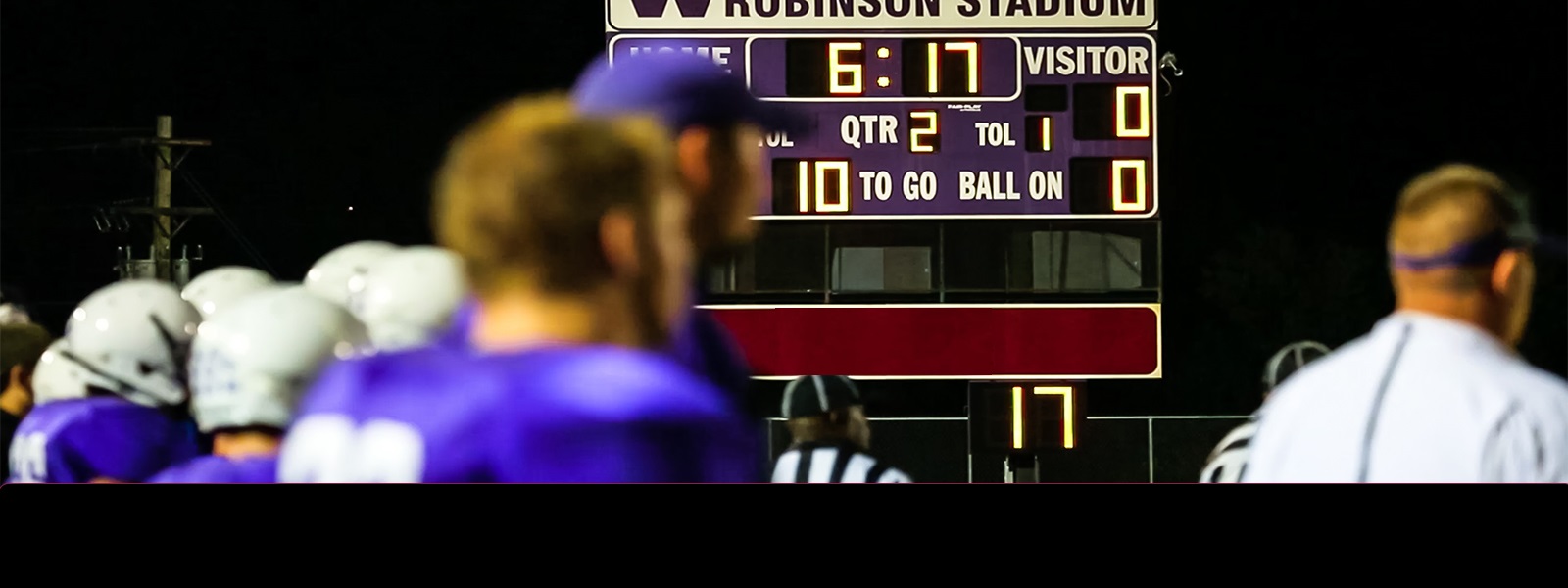 A high school football score board with Mati Trust Financial  logo.